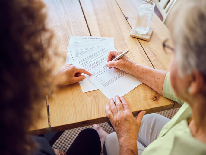 Old woman working with estate planning attorney