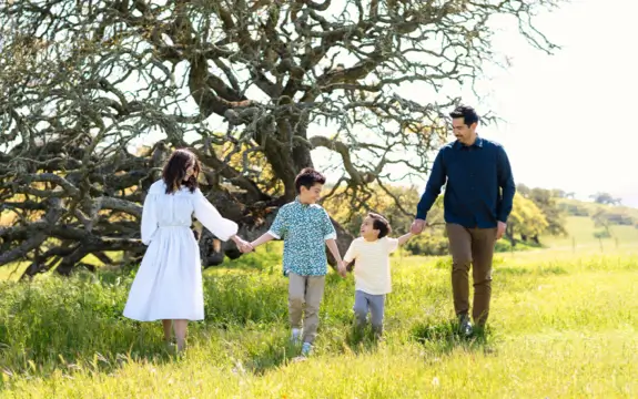 Biddle family walking in a prairie