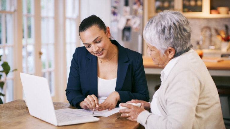 Older woman working on estate plan with attorney