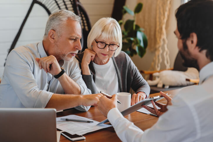 Older couple sitting with estate planning attorney